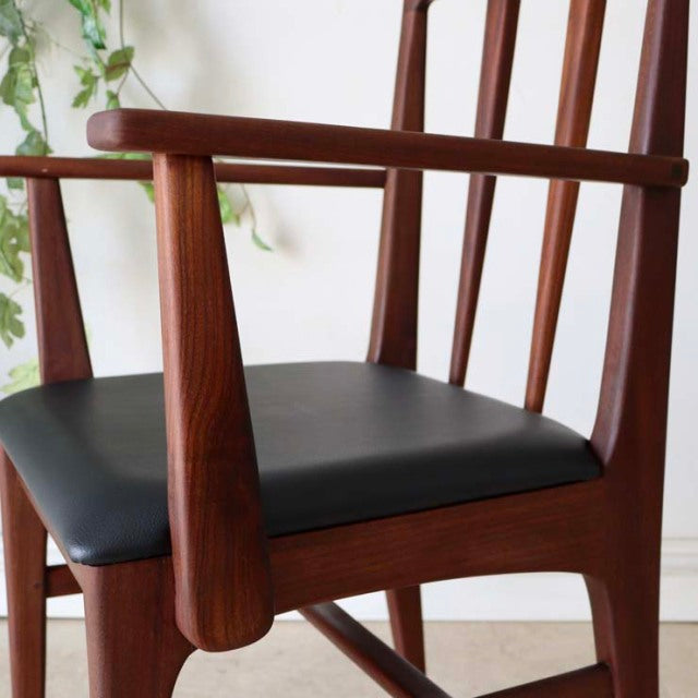 Vintage mid-century teak dining chair by Younger with British design, black cushioned seat, sleek teak armrests, and slender .
