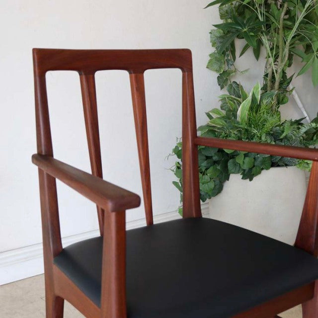Vintage teak dining chair by Younger featuring British mid-century design, tapered legs, and black upholstered seat with.