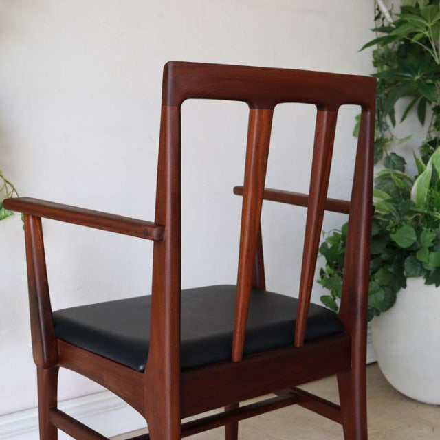Vintage teak dining chair by Younger with mid-century British design, featuring vertical slats and black seat cushion.
