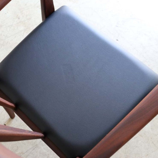 Vintage mid-century British dining chair by Younger with teak frame and black leather seat, featuring elegant curved.