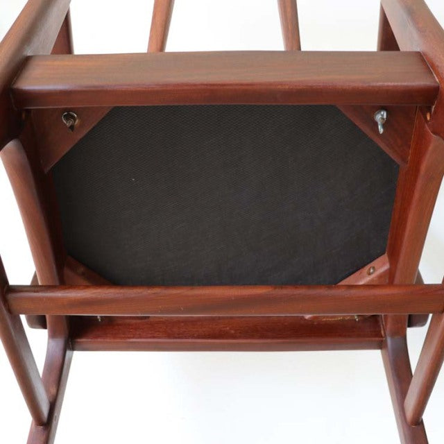 Underside view of vintage teak dining chair by Younger, British mid-century design with polished wood grain and sturdy frame.