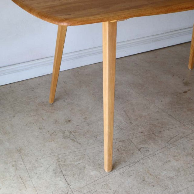 Vintage British mid-century teak dining table leg with tapered design and smooth wood grain finish.