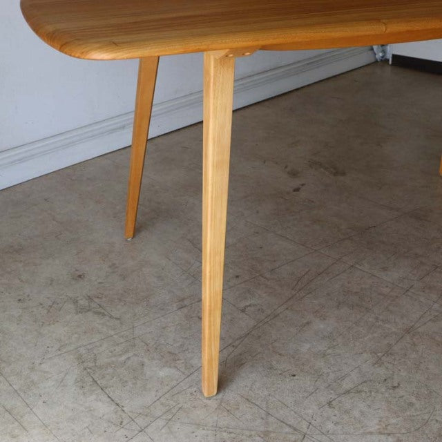 Mid-century British vintage Ercol dining table leg in smooth teak with tapered angle, showing warm wood grain.