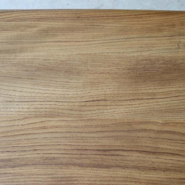 Vintage British mid-century Ercol dining table with smooth teak grain and rounded edges.
