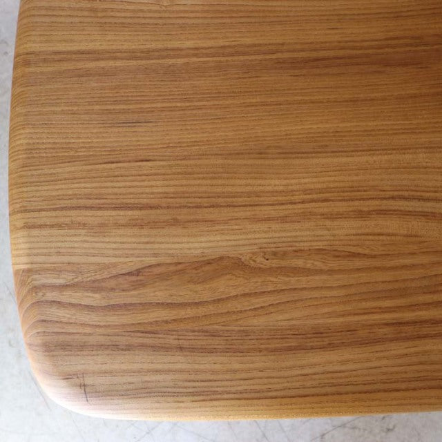 British vintage mid-century Ercol dining table in warm teak with smooth rounded edges and visible wood grain.