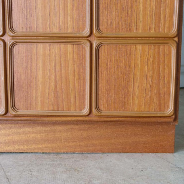 Close-up of British mid-century McIntosh sideboard made of vintage teak with detailed wood grain and sculpted square.