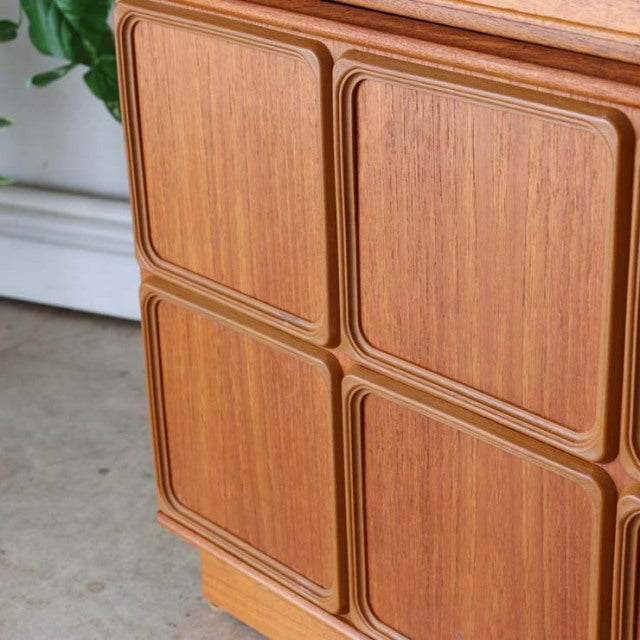 British mid-century McIntosh sideboard in vintage teak with pronounced wood grain and rounded panel doors.