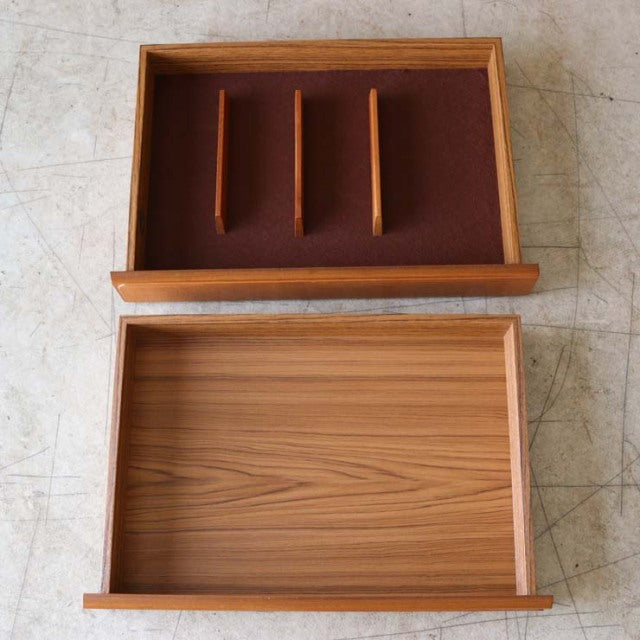 Open vintage British McIntosh teak sideboard drawers showing wood grain and mid-century design details.