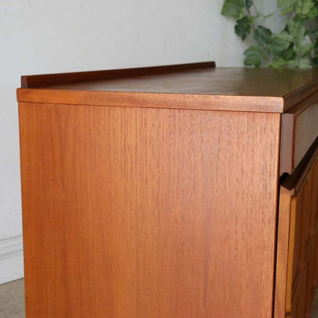 Vintage British McIntosh mid-century teak sideboard with smooth wood grain and clean edges.