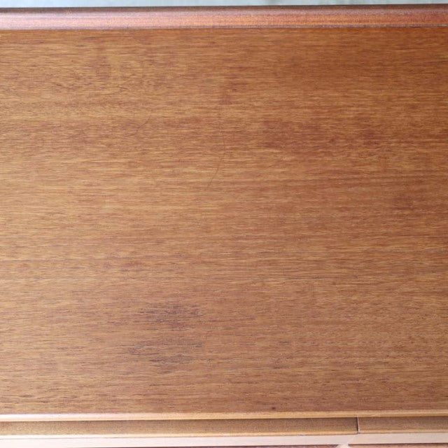Vintage British McIntosh teak sideboard top showcasing rich wood grain with smooth mid-century Scandinavian design finish.