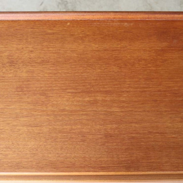 Mid-century British McIntosh teak sideboard top surface showing warm wood grain and smooth finish.