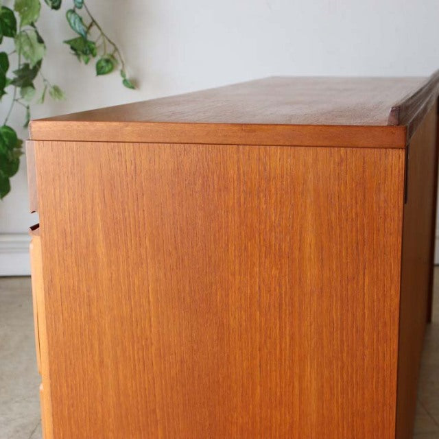Mid-century British McIntosh sideboard in vintage teak with rich wood grain and sleek straight legs.