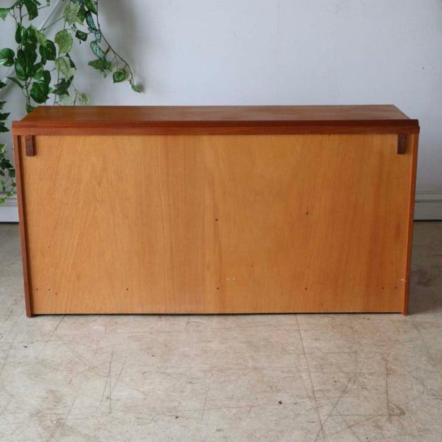 Vintage British McIntosh teak sideboard with clean mid-century lines, smooth wood grain, and minimalist rectangular form.