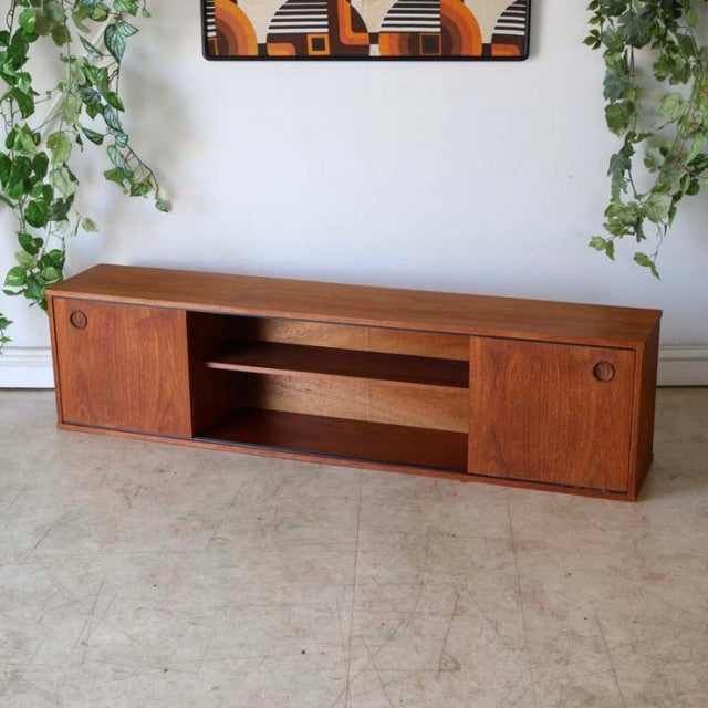 Mid-century vintage AVALON teak lowboard with British-Denmark design, featuring wood grain, sliding doors, and tapered legs.