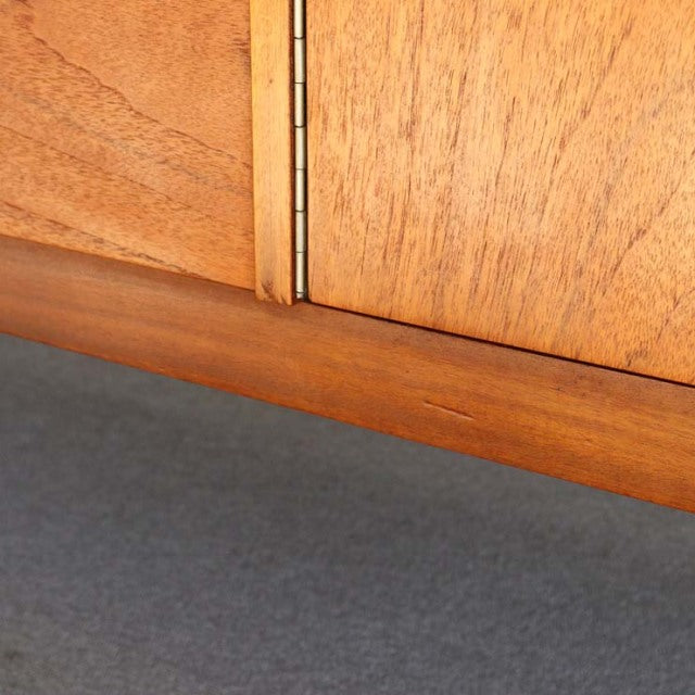 Close-up of vintage teak sideboard door edge showing fine wood grain and British mid-century craftsmanship by Nathan,.