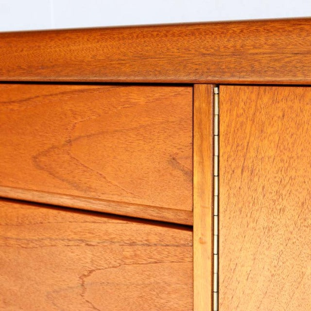 Close-up of vintage teak sideboard by British brand Nathan showing smooth wood grain, clean lines, and mid-century joinery.