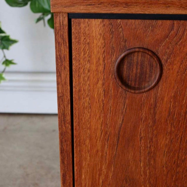 Vintage teak mid-century Avalon lowboard with smooth wood grain and carved circular handle detail, British-Danish style.