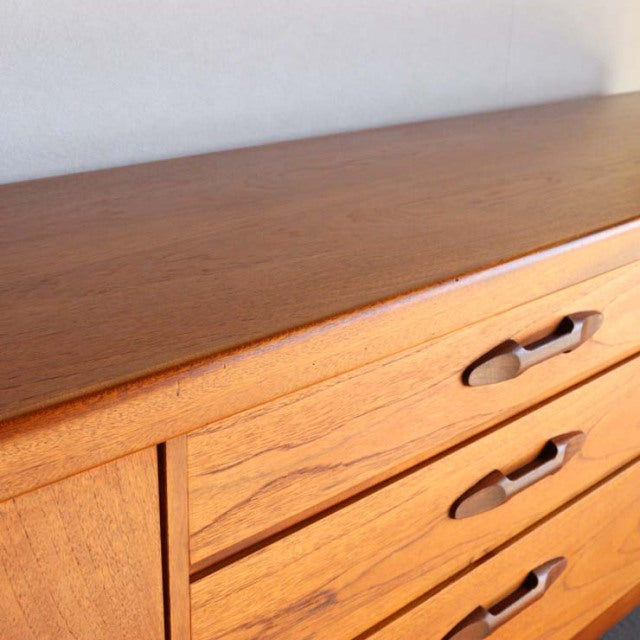 Vintage teak mid-century sideboard by Nathan, British-Danish design with smooth wood grain and recessed handles.