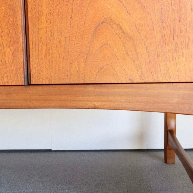 Mid-century teak sideboard by British brand Nathan, showcasing warm wood grain and sleek tapered legs with Danish design.