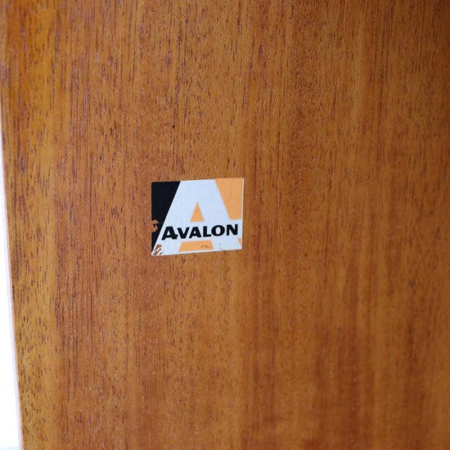 Close-up of AVALON vintage teak wood surface showcasing fine grain and mid-century British craftsmanship label.