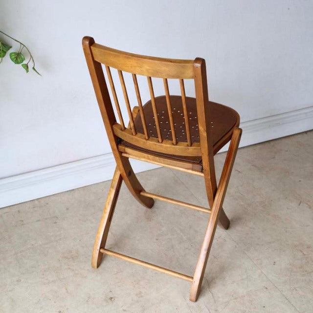 Set of two vintage teak folding chairs with British mid-century design, showcasing natural wood grain and spindled backrest, .