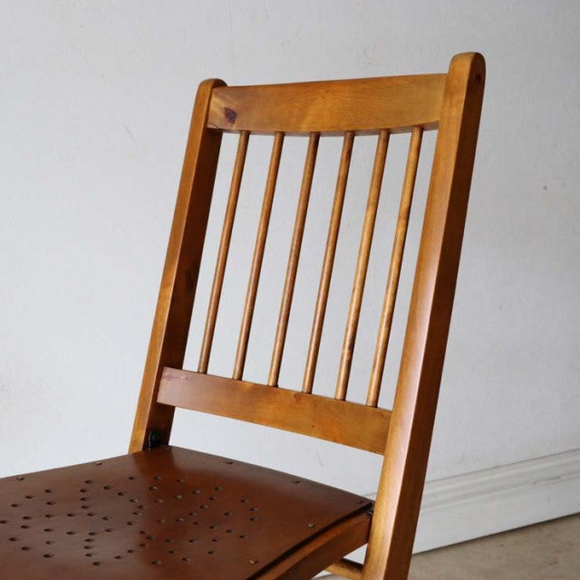 Set of two vintage teak folding chairs featuring British mid-century design, slender vertical slats on the backrest, natural .