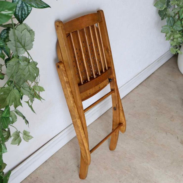Set of two vintage teak folding chairs with slatted backrests, British mid-century design, smooth wood grain, and sturdy.
