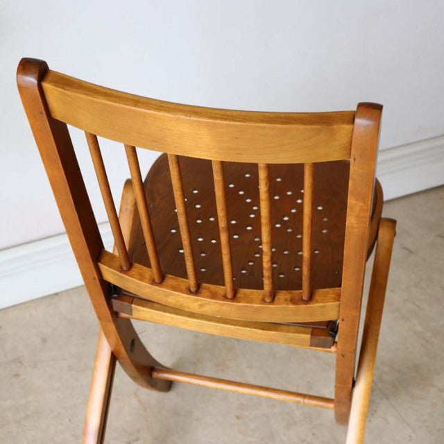 British vintage mid-century teak folding chair with slatted backrest and worn perforated seat.