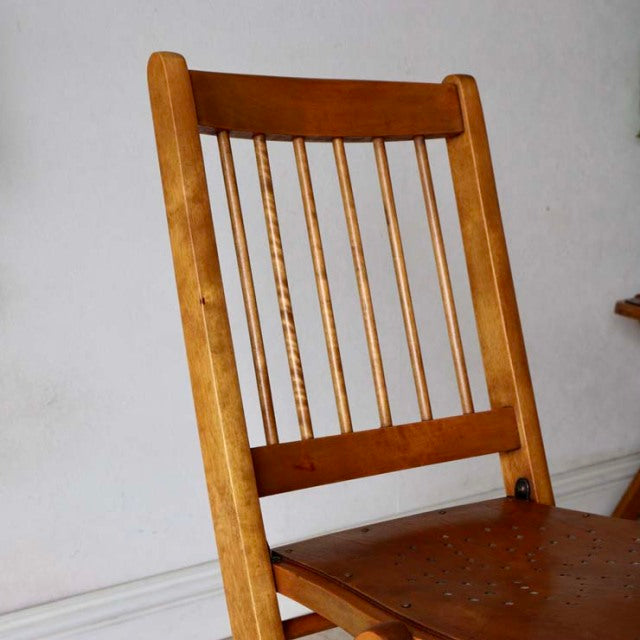 Mid-century British vintage teak folding chair with slender spindle back and warm wood grain.
