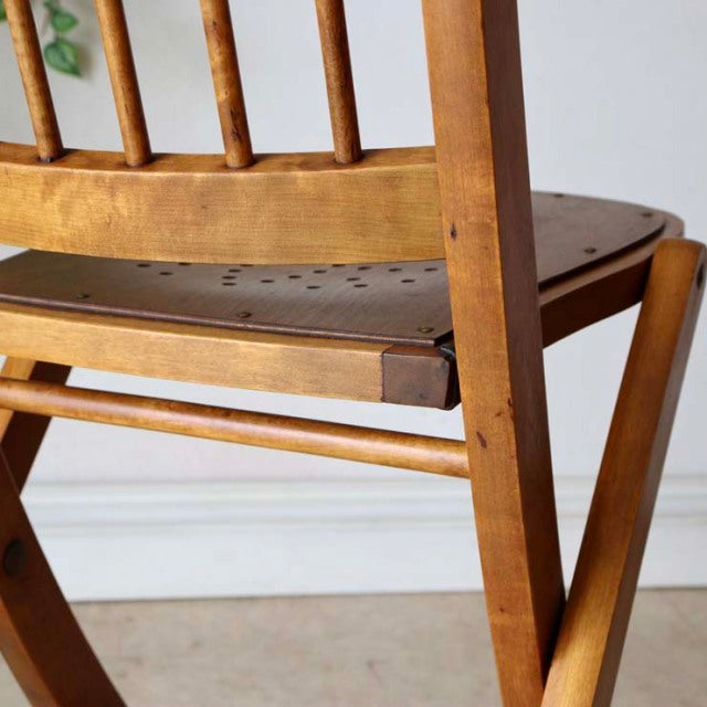 Pair of vintage British mid-century teak folding chairs with visible wood grain and perforated wooden seats.