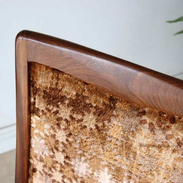 Close-up of vintage British G-Plan dining chair with teak wood frame and textured brown velour upholstery, mid-century.
