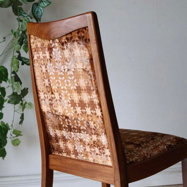 Mid-century British G-Plan dining chair in teak with floral patterned upholstery and tapered wooden legs.