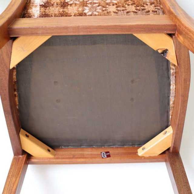 Underside of mid-century vintage G-Plan teak dining chair showing wooden frame, fabric lining, and corner braces.