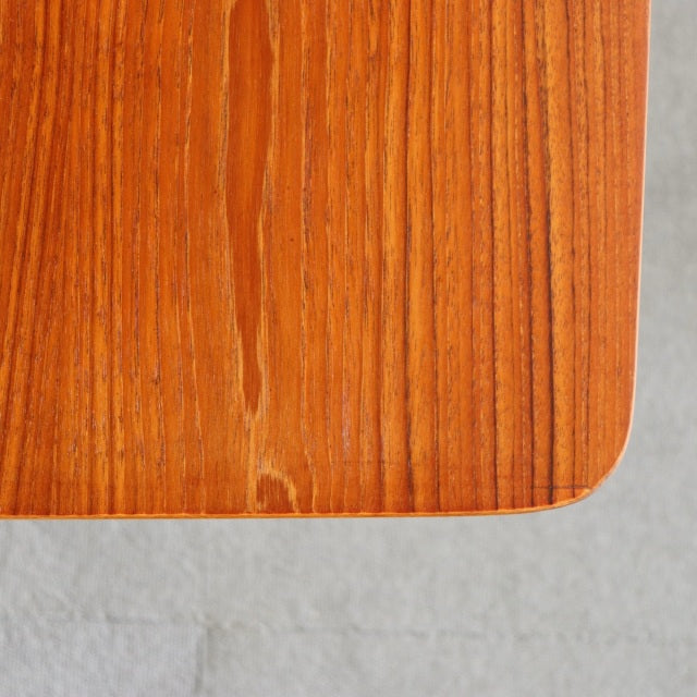 Corner detail of vintage teak mid-century British Denmark coffee table with rich wood grain and smooth rounded edge.