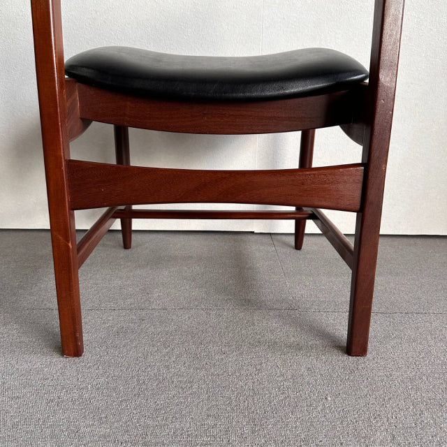 Mid-century British vintage dining chair with rich teak wood frame and black leather seat cushion, showcasing smooth wood.