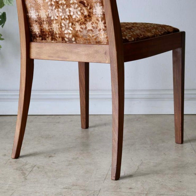 Set of four G-Plan vintage teak dining chairs with mid-century British design, curved legs, and patterned fabric upholstery.