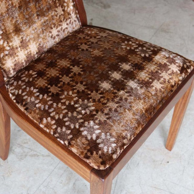 Mid-century British G-Plan teak dining chair with floral-patterned brown velvet seat and angled wooden legs.