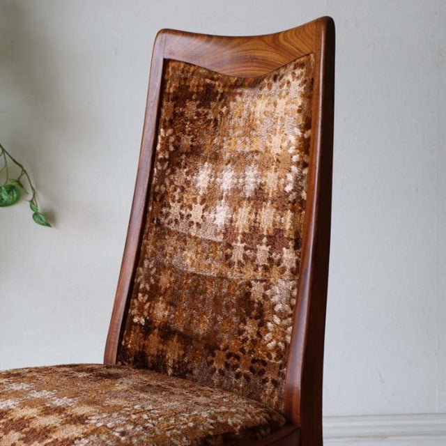 Vintage British mid-century G-Plan dining chair with teak frame and patterned brown fabric upholstery, tapered legs.