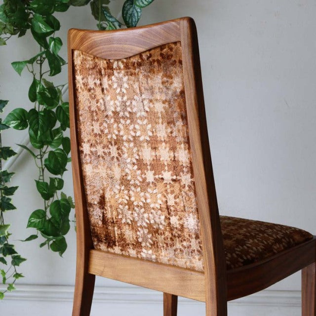 Vintage British G-Plan teak dining chair with patterned mid-century upholstery and sleek wooden legs.