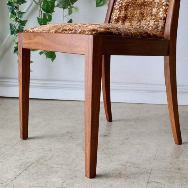 Set of four vintage British G-Plan dining chairs in mid-century teak with woven fabric seats and tapered legs.
