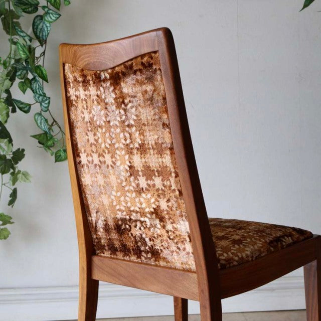 Set of four vintage G-Plan teak dining chairs with British mid-century design and textured patterned upholstery.