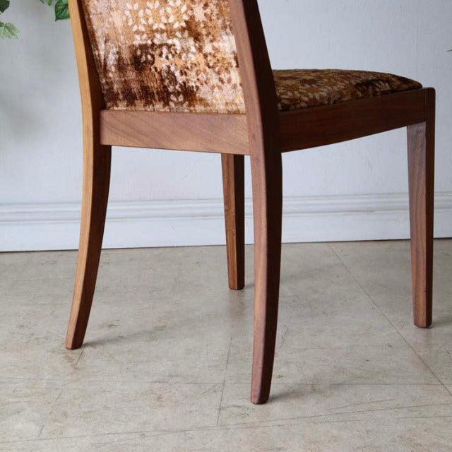 Set of four vintage G-Plan teak dining chairs with tapered legs and textured mid-century British design from Denmark.