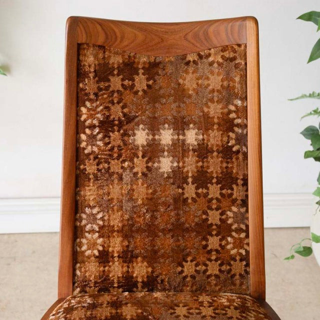 Vintage G-Plan dining chair with teak frame, mid-century British design, patterned fabric backrest with warm wood grain and.