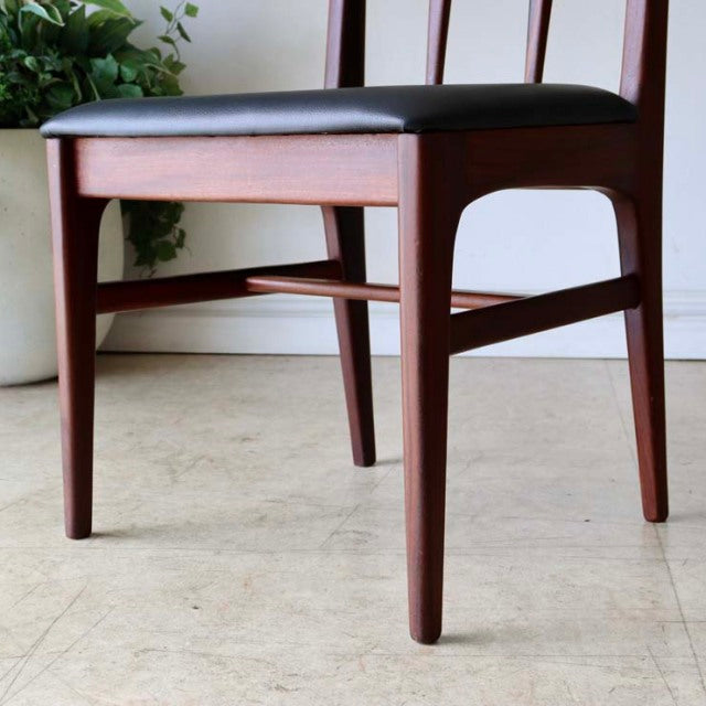 Set of four vintage British mid-century dining chairs by A.Younger Ltd., crafted from rich teak wood with sleek tapered legs .