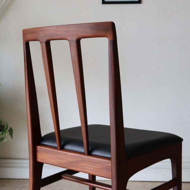 Set of four vintage British dining chairs by A.Younger Ltd., mid-century teak wood frames with clean lines and black leather .