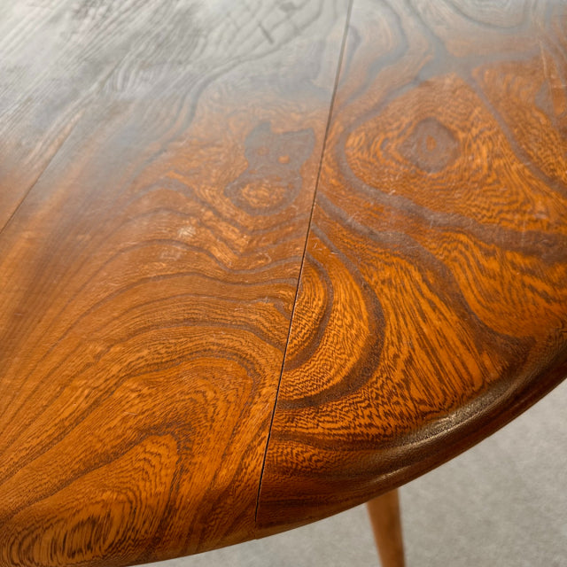 Vintage British mid-century teak breakfast table top with distinctive wood grain and smooth rounded edge.