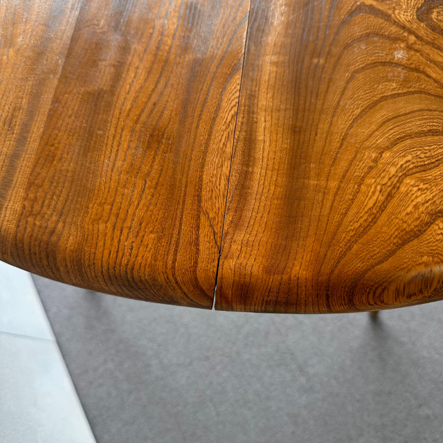 Close-up of vintage British mid-century ERCOL teak breakfast table edge showing rich wood grain and smooth rounded corners.