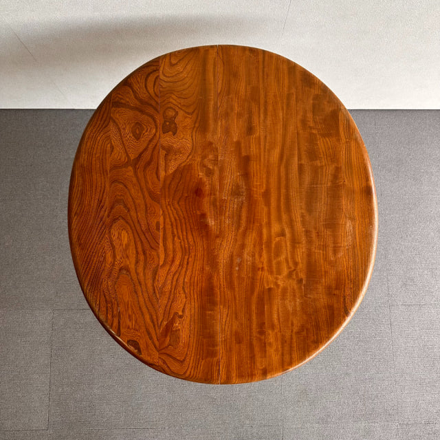 Vintage teak British mid-century ERCOL dining table with rich wood grain and rounded edges.