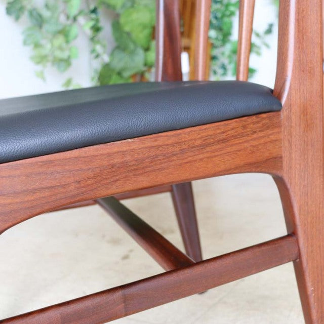 Vintage teak Younger dining chair with British mid-century design, black cushioned seat, sleek wood grain and tapered legs.