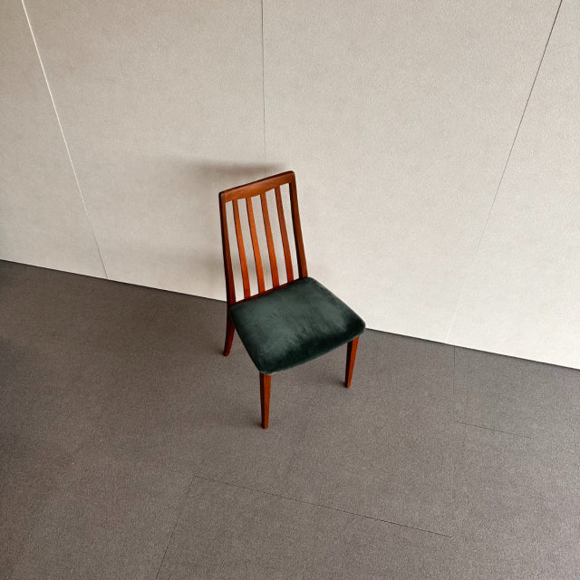 Vintage British G-Plan mid-century teak dining chair with vertical slat back and dark upholstered seat.